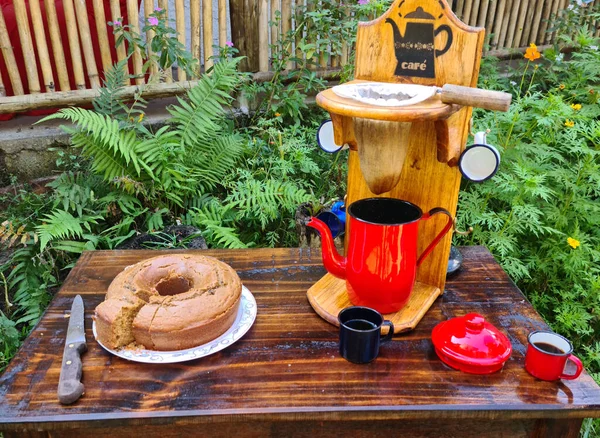 Red coffee maker and cloth filter, red teapot. rustic coffee, breakfast in the country with homemade cake