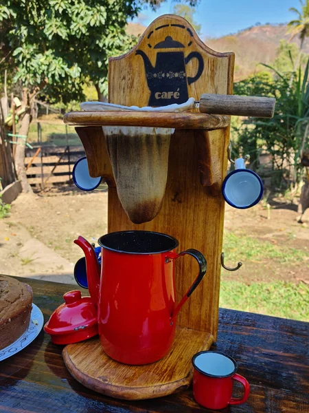 Red coffee maker and cloth filter, red teapot. rustic coffee, breakfast on the farm with homemade cake