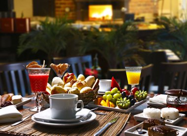 Breakfast with buns, fruits and cakes