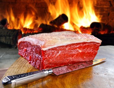 Fresh meat table with fire on background