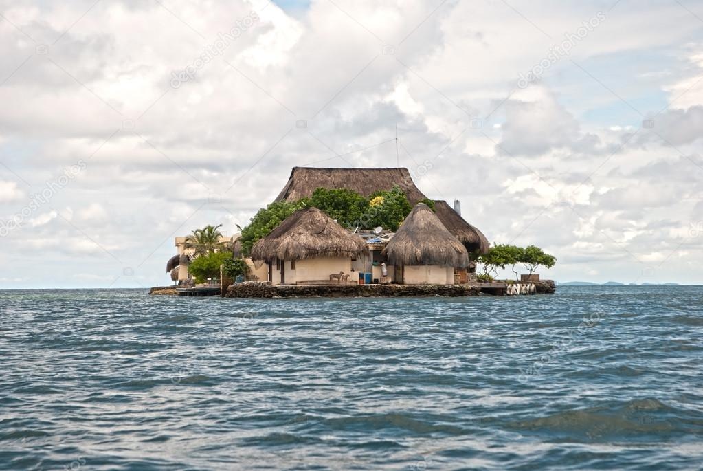 Bungalows on green island in ocean