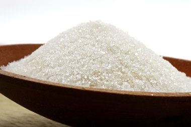 White sugar in wooden plate