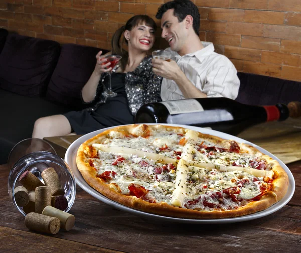 Paar cocktail drinken en eten van pizza — Stockfoto
