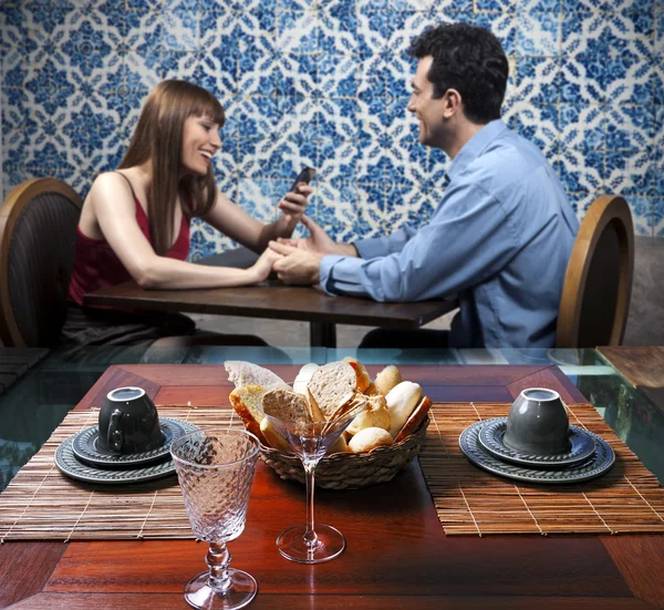 Young smiling couple in restaurant — Stock Photo, Image