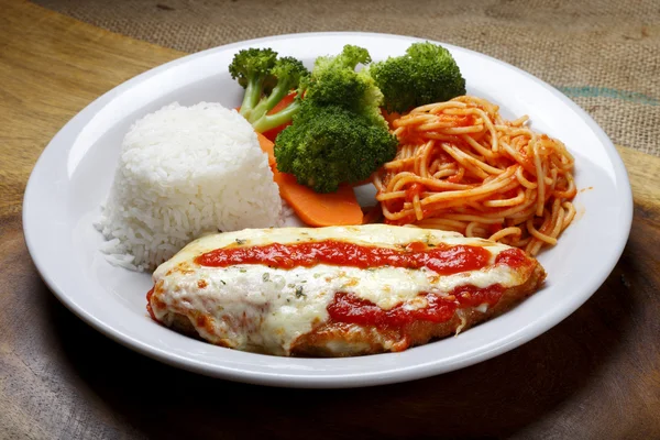 The steak parmigiana with pasta and rice — Stock Photo, Image