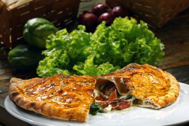 Pizza Calzone on a white dish clipart