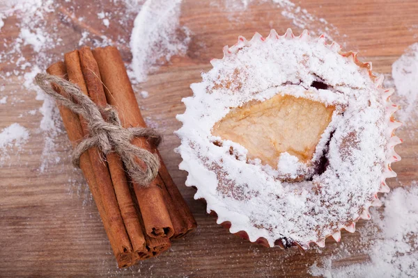 Muffins and cinnamon sticks — Stock Photo, Image