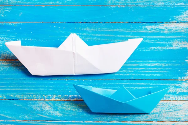Origami de papel de barco sobre el fondo azul —  Fotos de Stock