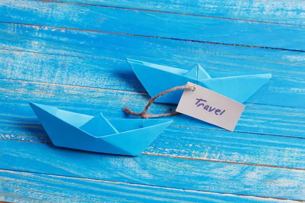 Paper Boat with a sign Travel - travel concept