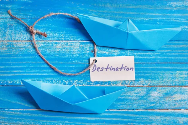 Paper Boat with a sign Destination - travel concept — Stock Photo, Image
