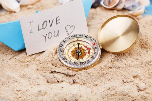 Compass in the sand with sign - I love you — Stock Photo, Image