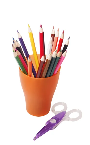 Colored pencils in a orange glass — Stock Photo, Image