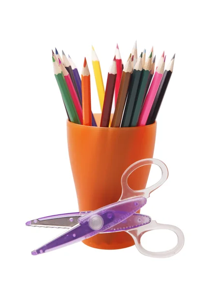 Colored pencils in a orange glass — Stock Photo, Image