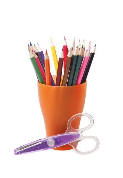 Colored pencils in a orange glass — Stock Photo, Image