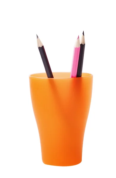 Colored pencils in a orange glass — Stock Photo, Image