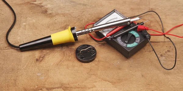 Soldering iron on a wooden table — Stock Photo, Image