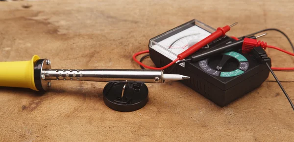 Soldering iron on a wooden table — Stock Photo, Image