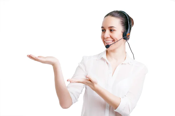 Portrait of happy smiling cheerful young support phone operator in headset showing copyspace area or something, isolated on white background — Stock Photo, Image