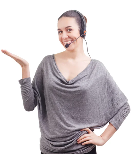 Portrait of happy smiling cheerful young support phone operator in headset showing copyspace area or something, isolated on white background — Stock Photo, Image