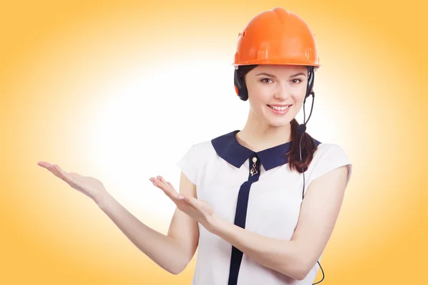 Portrait of happy cheerful young support phone operator in builder helmet — Stock Photo, Image