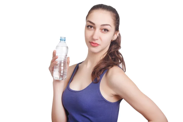 Beautiful athletic girl looks hold a bottle — Stock Photo, Image