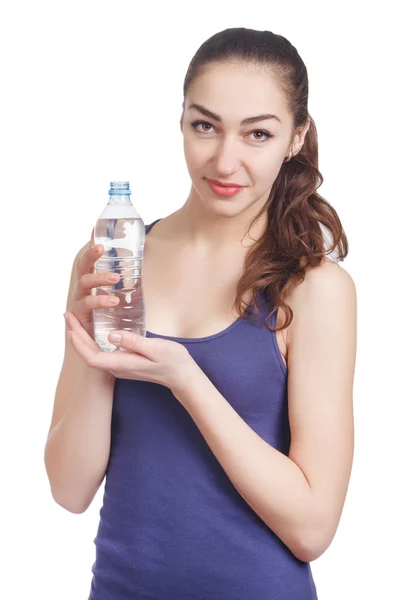 Beautiful athletic girl looks hold a bottle — Stock Photo, Image