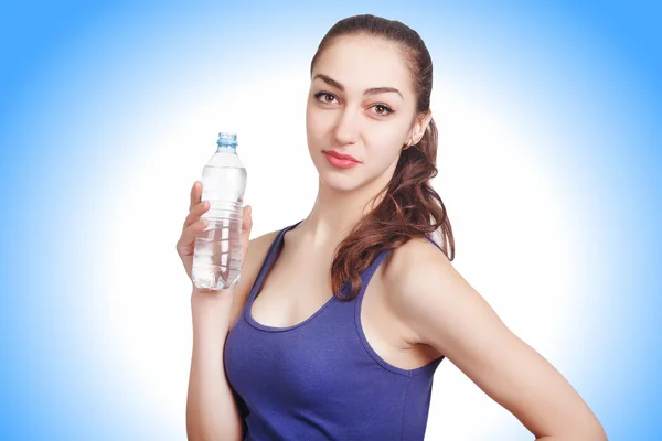 Beautiful athletic girl looks hold a bottle — Stock Photo, Image