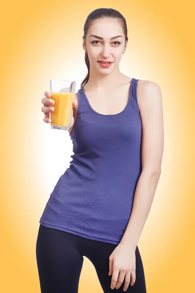 Beautiful girl holding a glass of juice. Female model hold orange juice glass — Stock Photo, Image