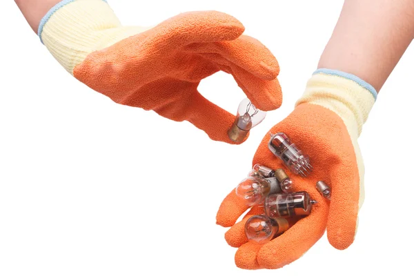 Hand in gloves holding a car bulbs — Stock Photo, Image