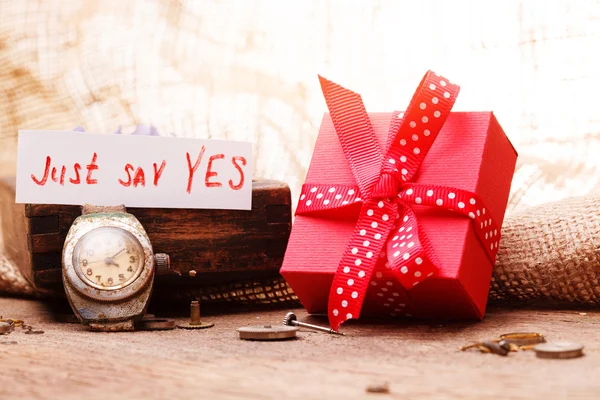 Caja de regalo roja atada cinta roja y texto "solo di que sí " —  Fotos de Stock