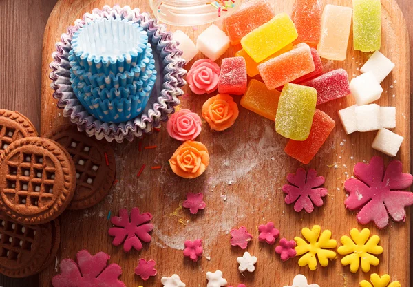 Sweets and candies on a wooden table — Stock Photo, Image