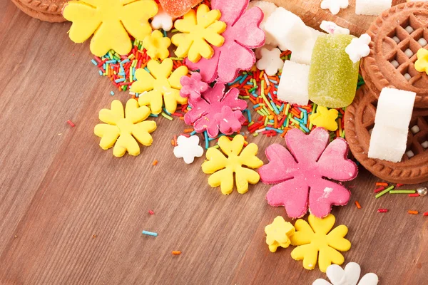 Sweets and candies on a wooden table — Stock Photo, Image