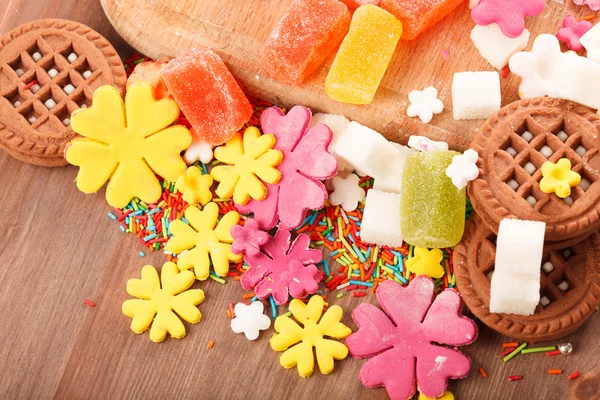 Sweets and candies on a wooden table — Stock Photo, Image