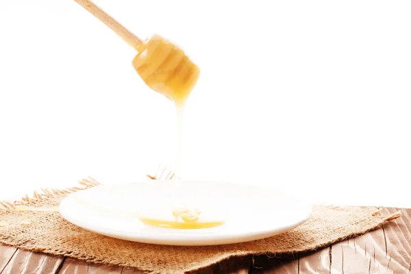 Honey is dripping from the spoon — Stock Photo, Image