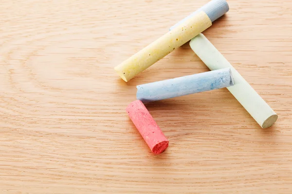 Chalk on wooden background — Stock Photo, Image