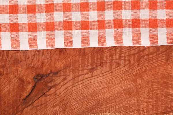 Tablecloth red and white checkered wavy on wooden table — Stock Photo, Image