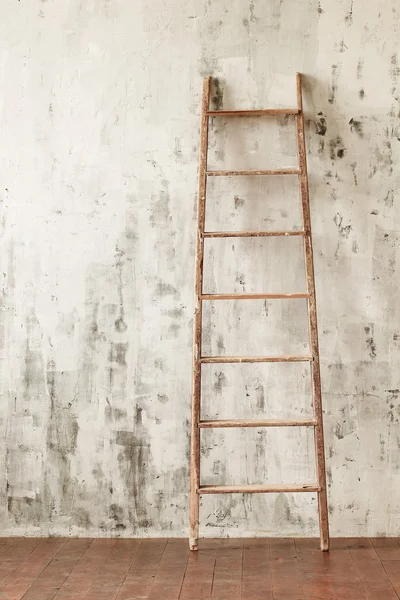 Beton duvar arka plan üzerinde boş bir odada bir ahşap merdiven