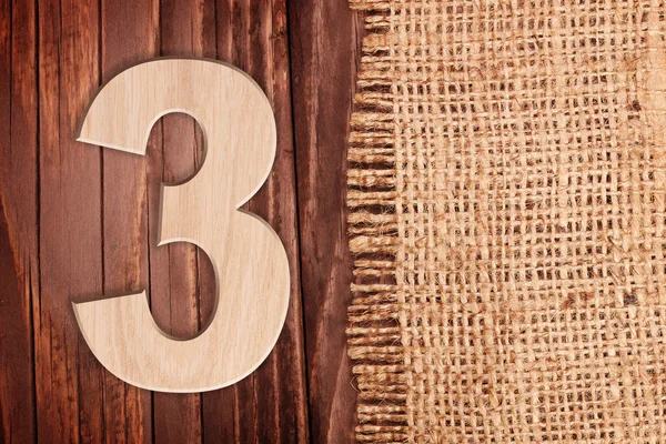 Ahşap basamak bir simgesi - 3. Ahşap masa arka plan wih çuval üzerinde