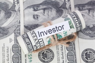 Para ve iş fikri, dolar faturaları yatırımcı işaretiyle - bir ip ile bağlı