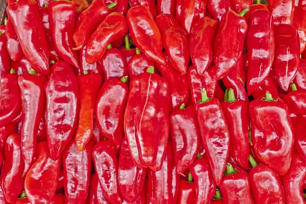 Tasty background, orange horn peppers closeup — Stock Photo, Image