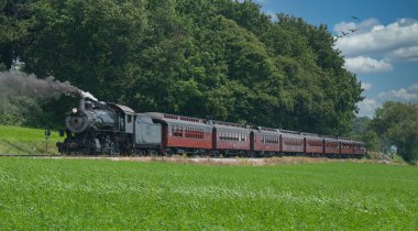 Antika Buhar Yolcusu Treni Yeşil Tarlalı Amish kırsalında bir sürü siyah duman tüttürüyor