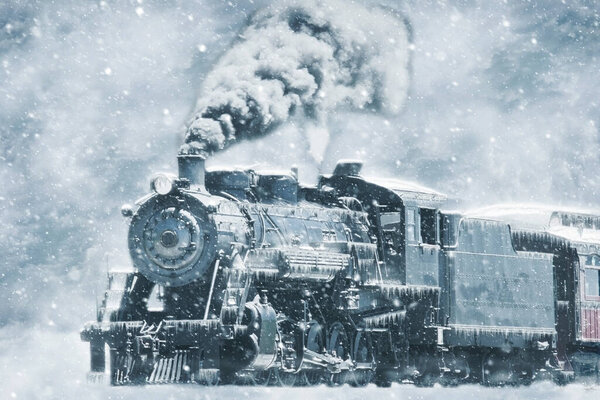 A Restored Steam Engine Steamed Up in a Snow Storm With Icicles