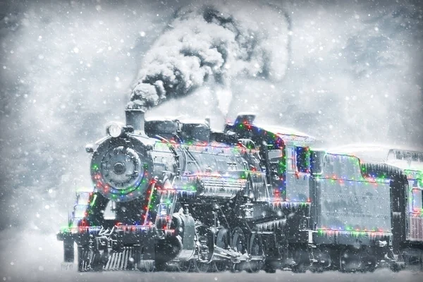 Restored Steam Engine with Christmas Lights on it in a Snow Storm — стоковое фото