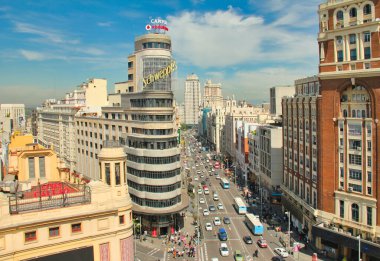 Madrid, Spain - June 6, 2016: Traffic of cars and people walking past the magnificent architecture in Madrid, Spain on June 6, 2016