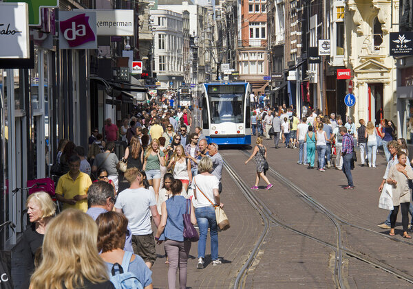 People shopping and tram in Amsterdam, Holland