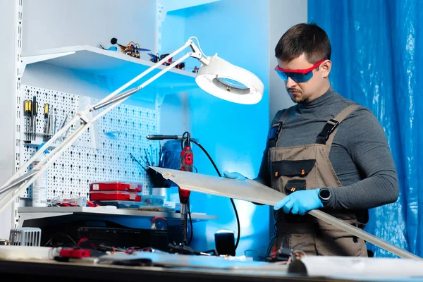 Junge männliche Ingenieure oder Techniker testen die Qualität von Drohnendetails im Labor. Flugzeuge, die GPS-fähig sind. Kohlenstoff. — Stockfoto