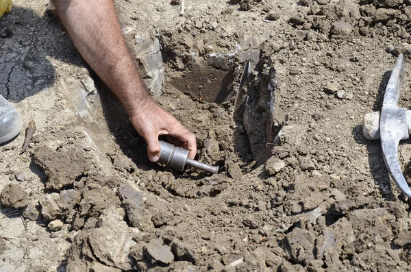 Collecting underground samples from drilled special prepared assessment point — Stock Photo, Image