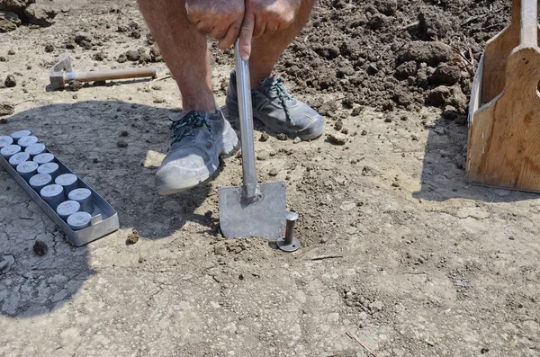 Collecting underground samples from drilled special prepared assessment point — Stock Photo, Image