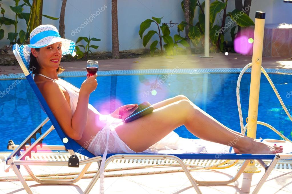 By the pool with a glass of red wine