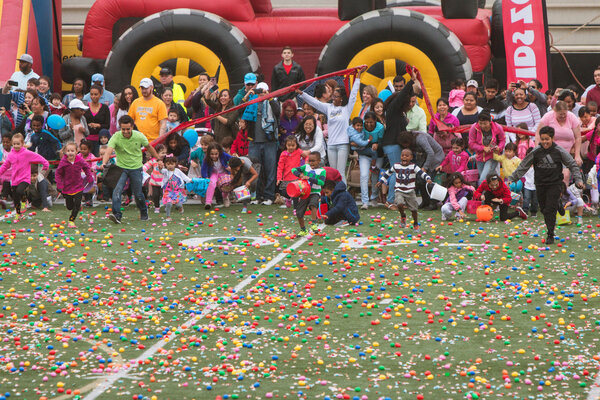 Kids Dash Onto Football Field For Community Easter Egg Hunt